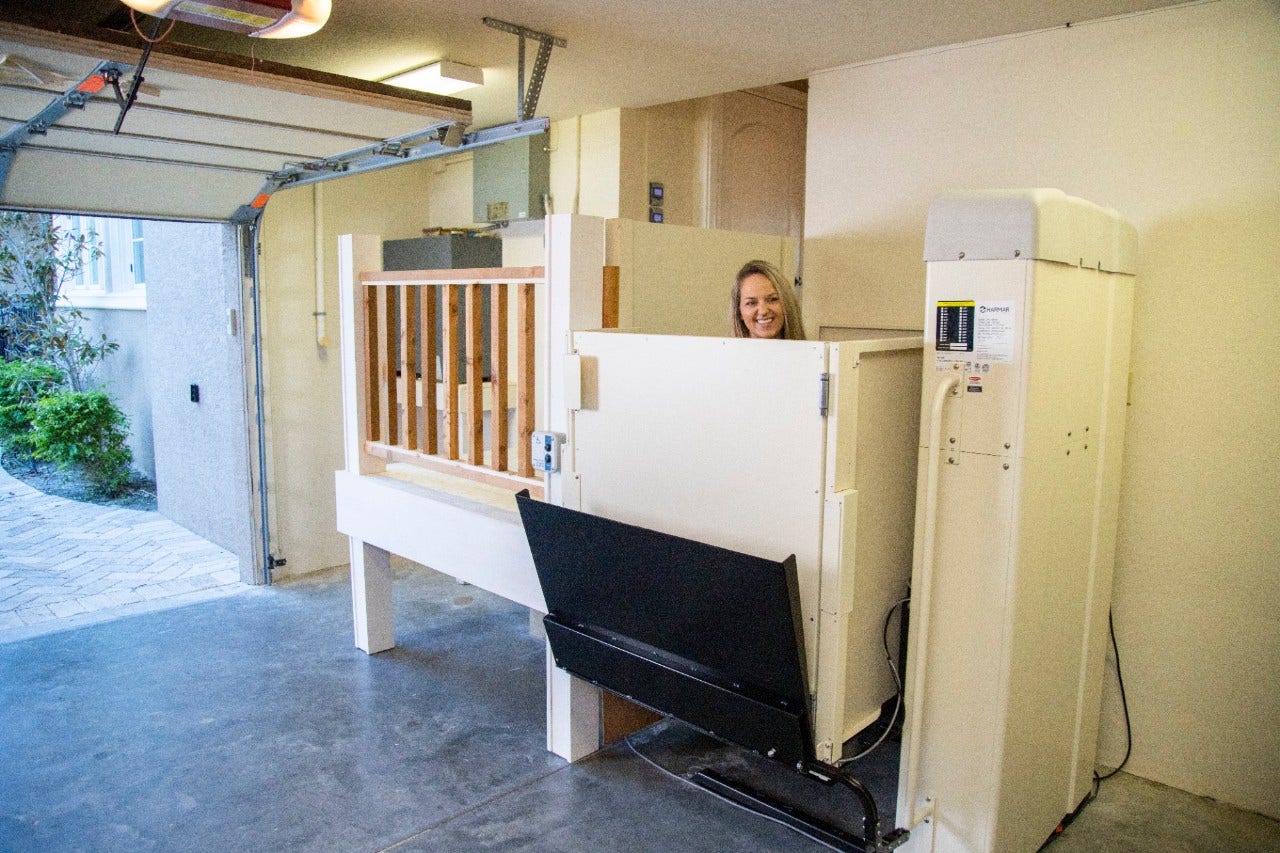 Harmar Highlander Vertical Platform Lift woman using lift