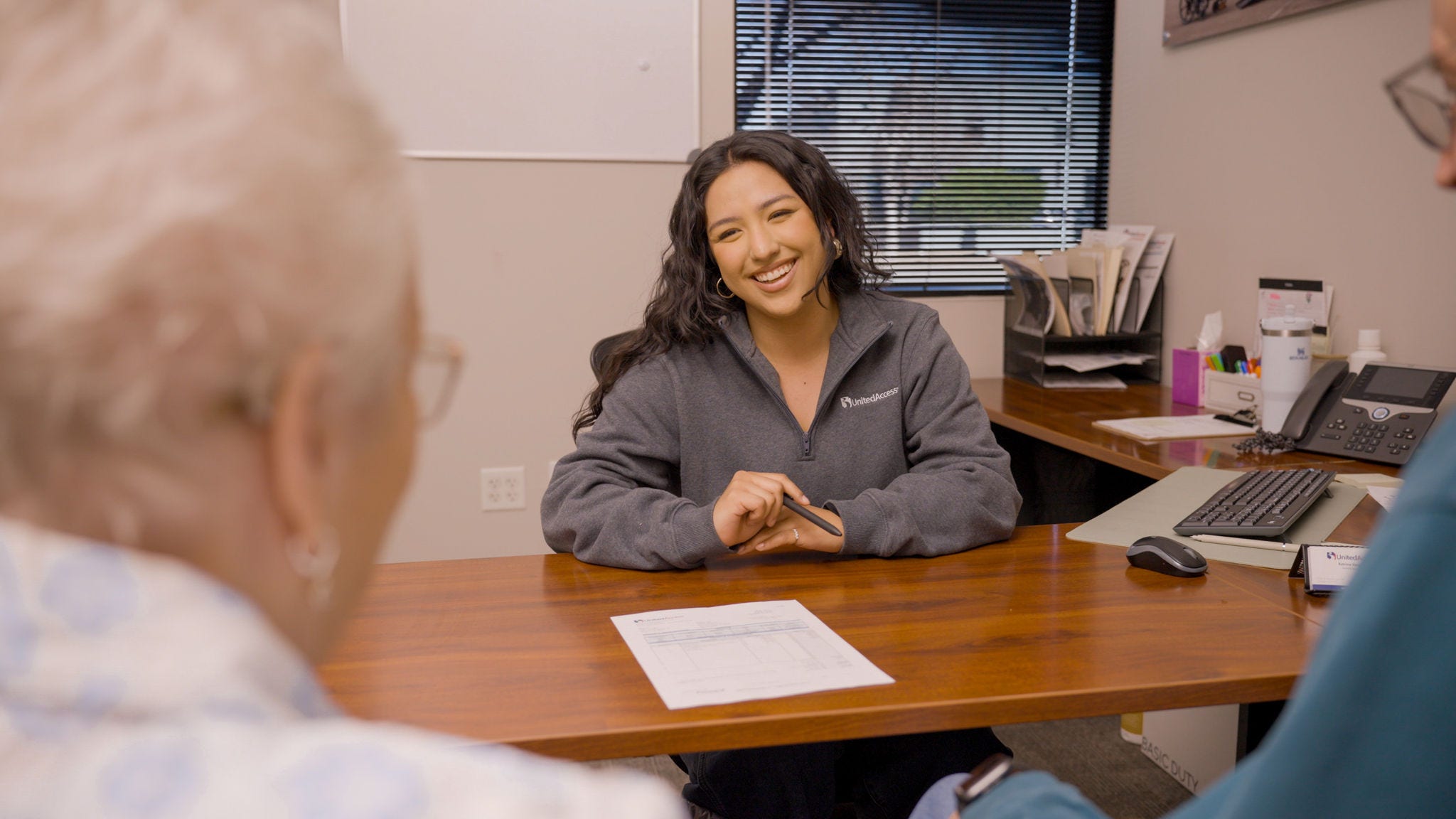 mobility specialist sitting at desk
