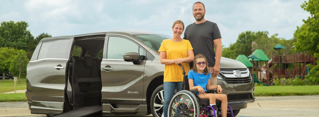 family standing in front of wheelchair van rental