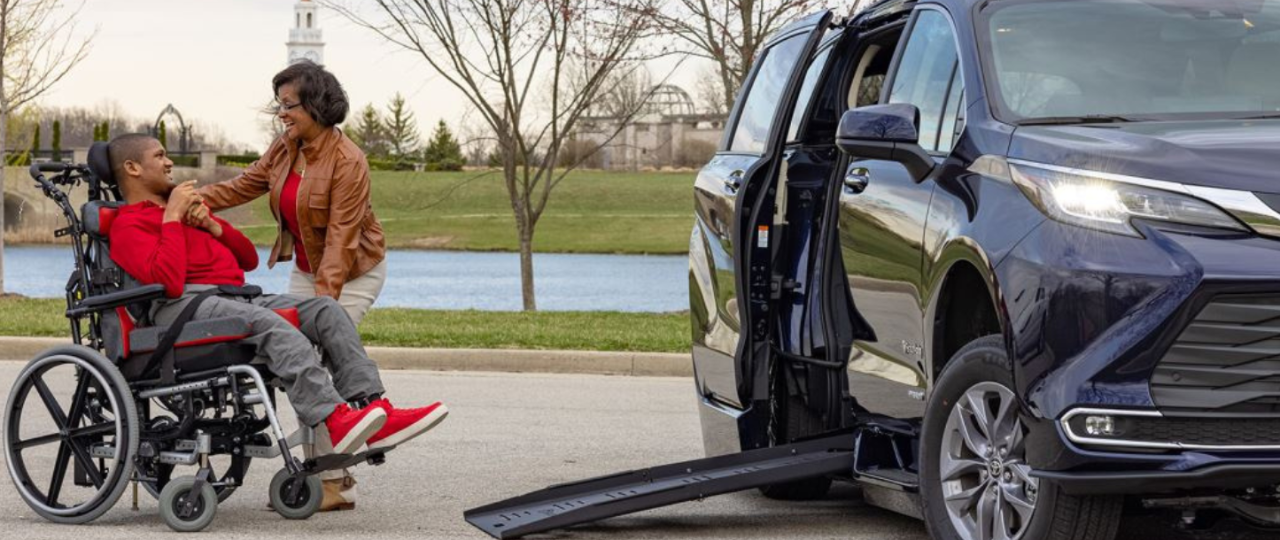man in wheelchair getting into a handicap van rental