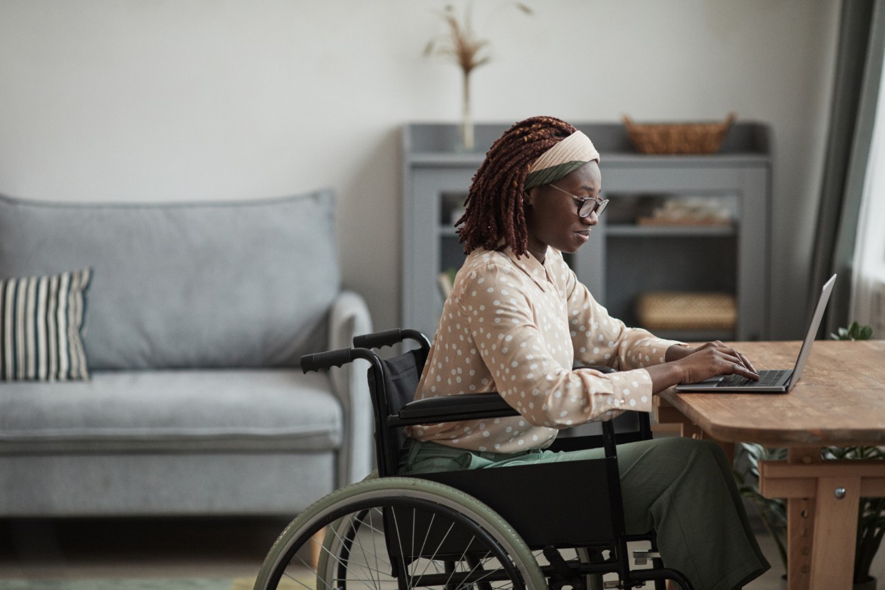 how to fund wheelchair accesible equipment woman on laptop at table