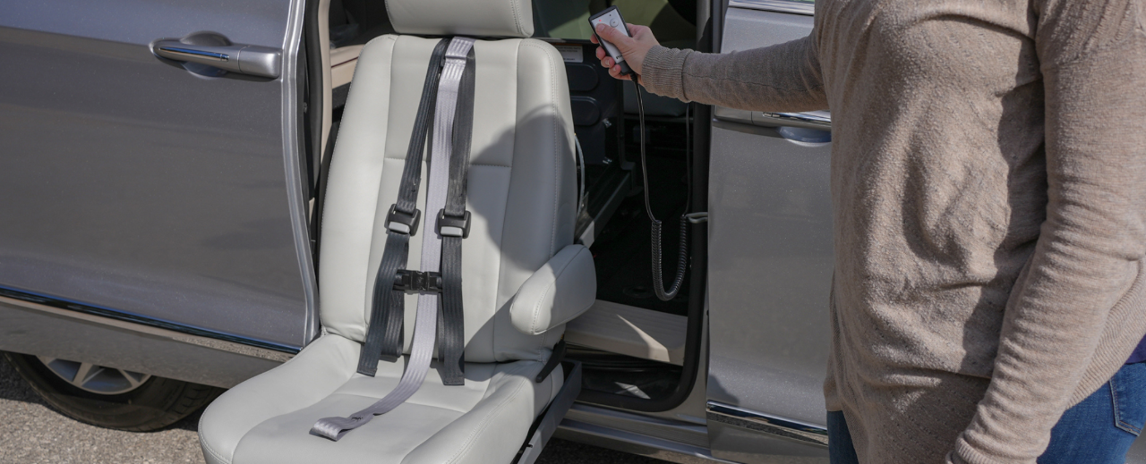 Lady using Remote to lower a Turning Swivel Seat