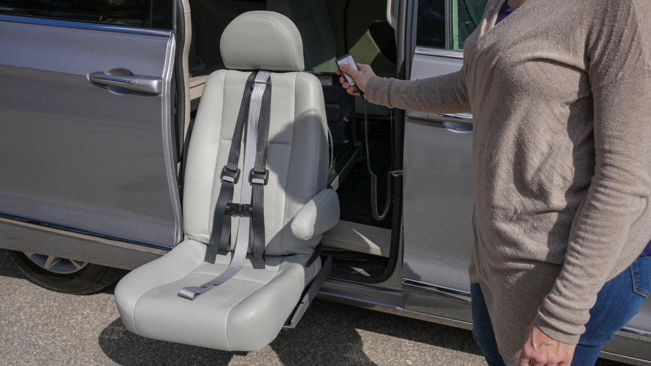 man using remote to lower his transfer seat