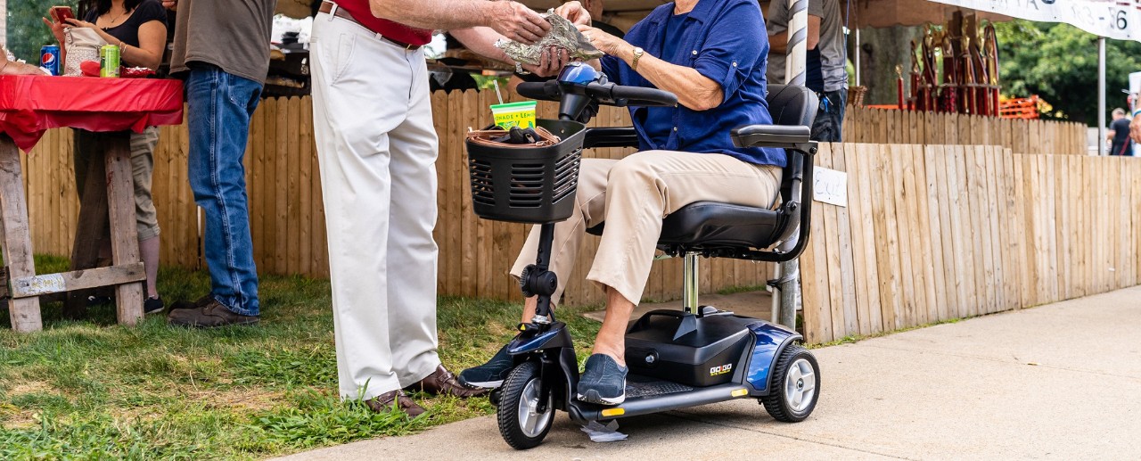 man with women in fast mobility scooter