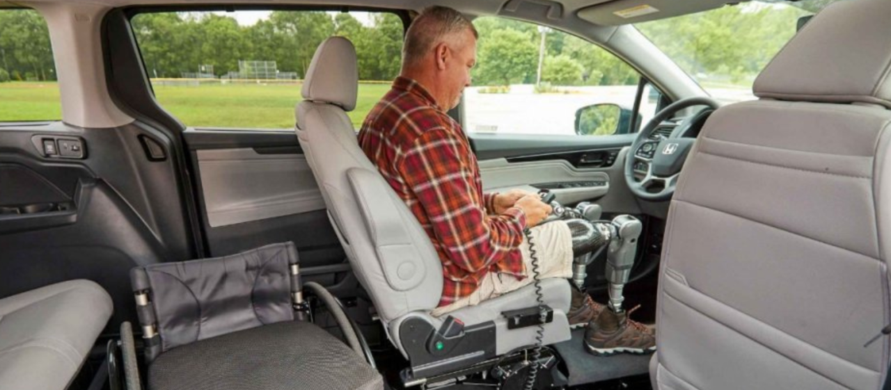 Man in a transfer seat geting into his wheelchair
