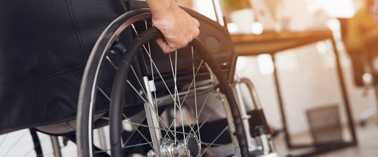 A man is sitting in a wheelchair.