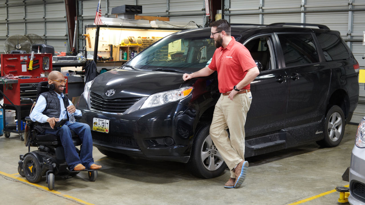 Man help a person in a wheelchair with the Wheelchair Accessible Van