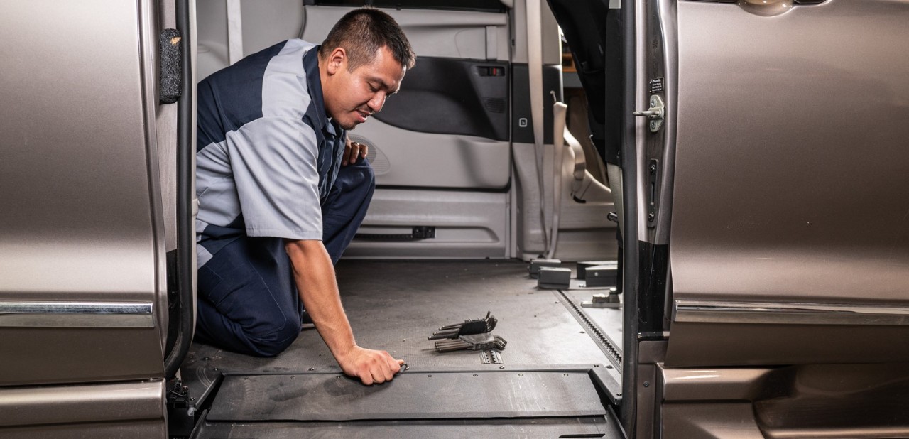 man servicing wheelchair van
