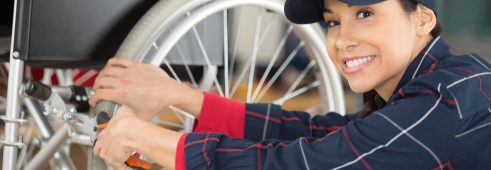 woman is repairing a wheelchair in garage