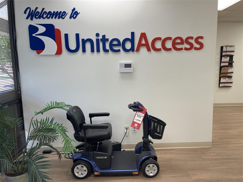 United Access logo on wall and mobility scooter
