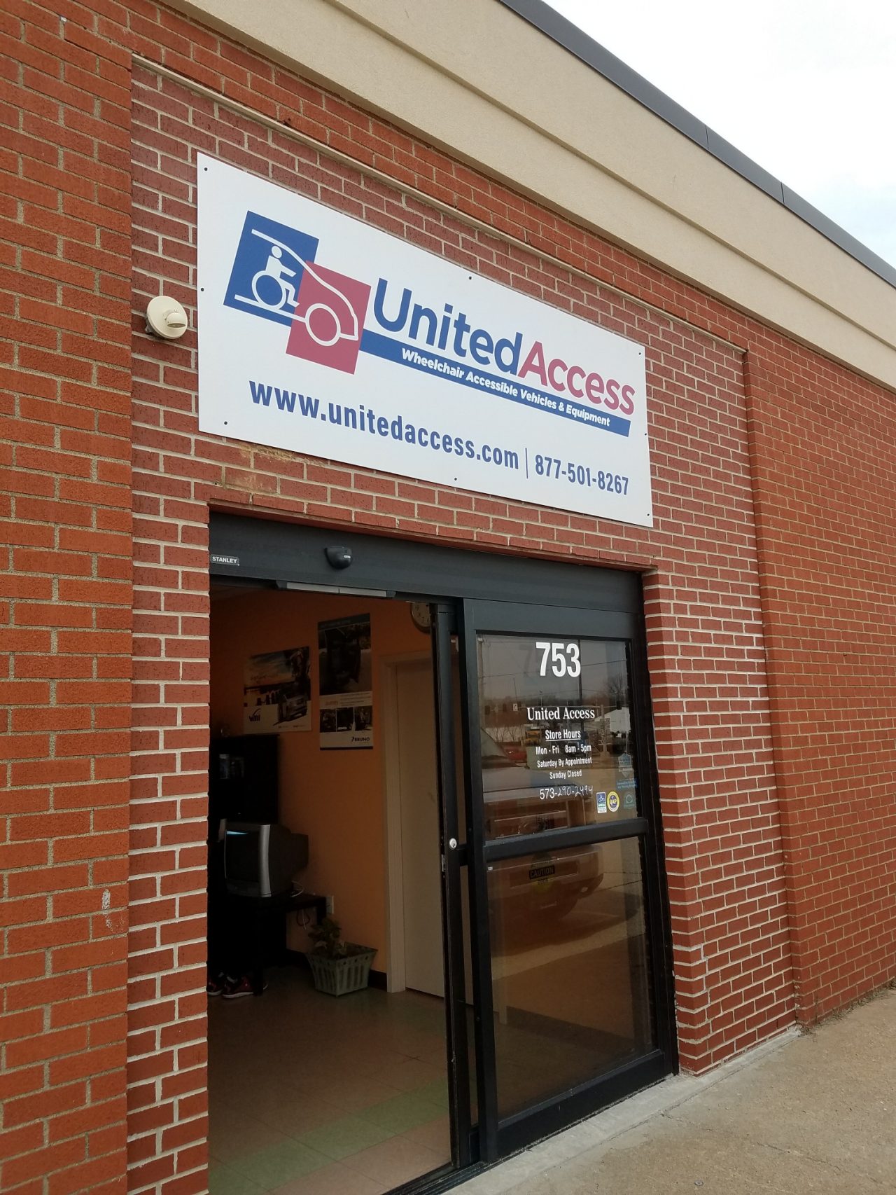 three team members outside of store front