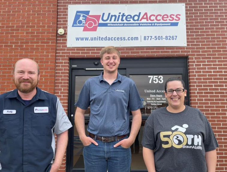 three team members outside of store front