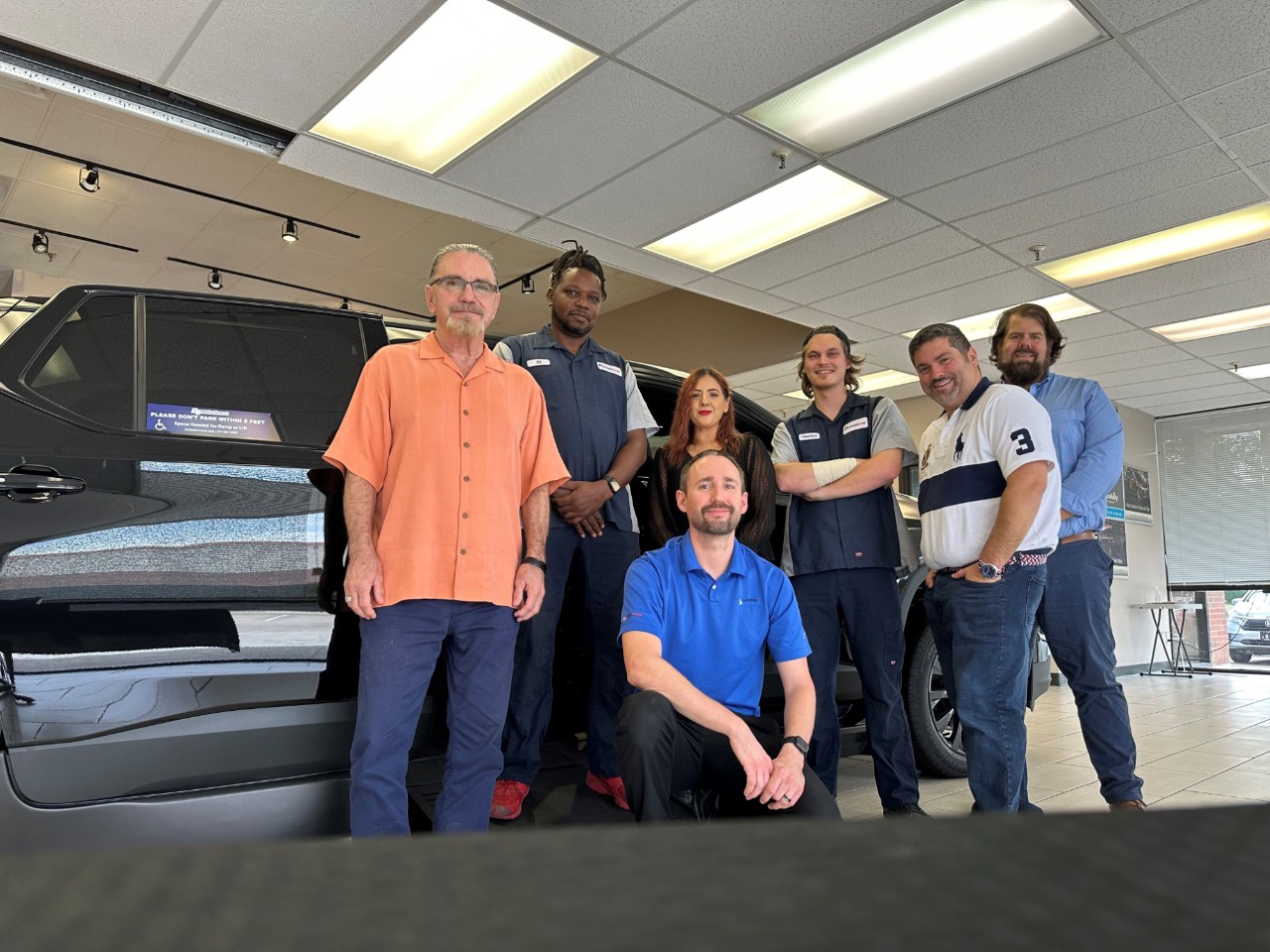 team photo in front of an accessible van