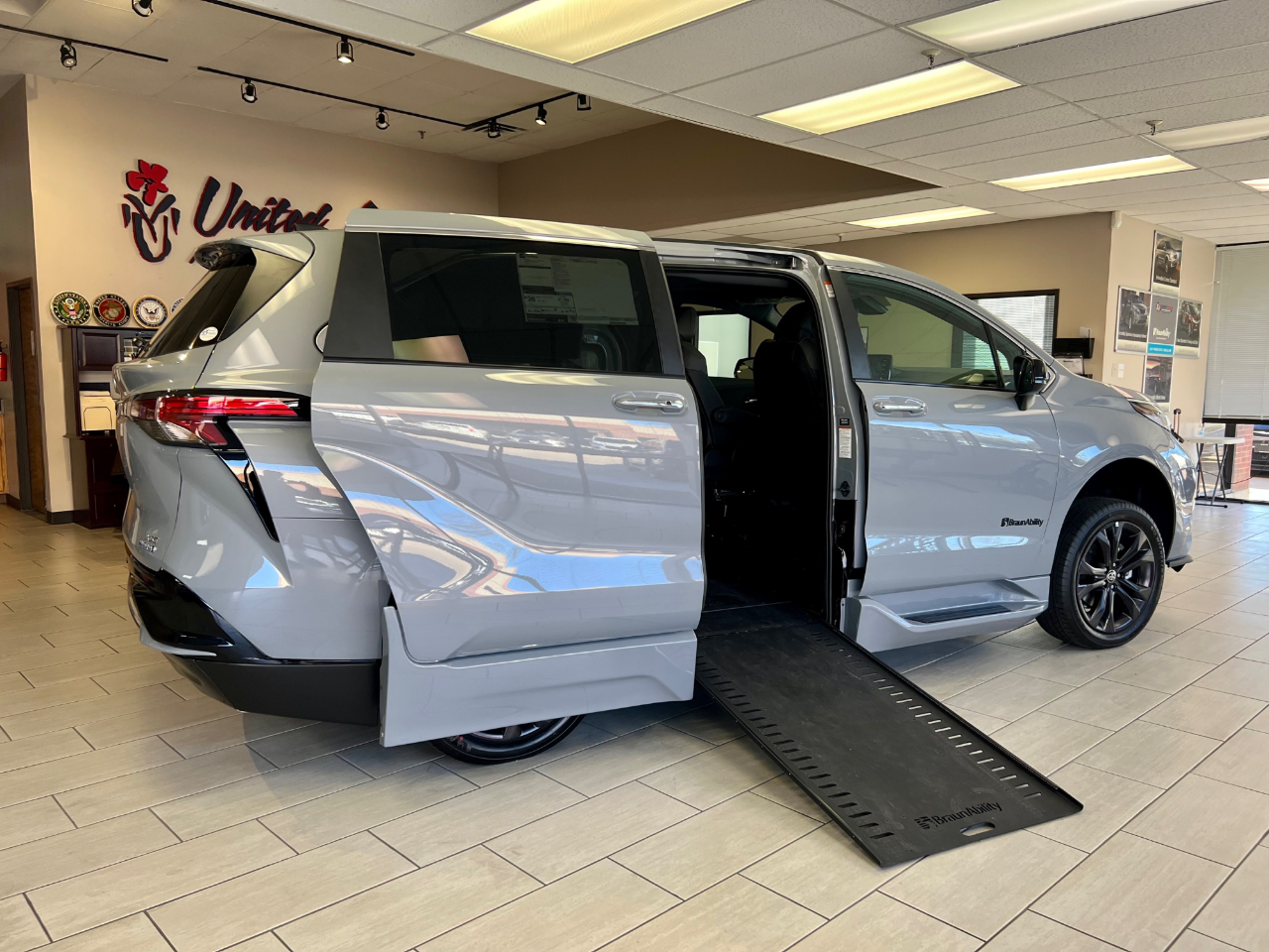wheelchair accessible van in showroom with ramp deployed