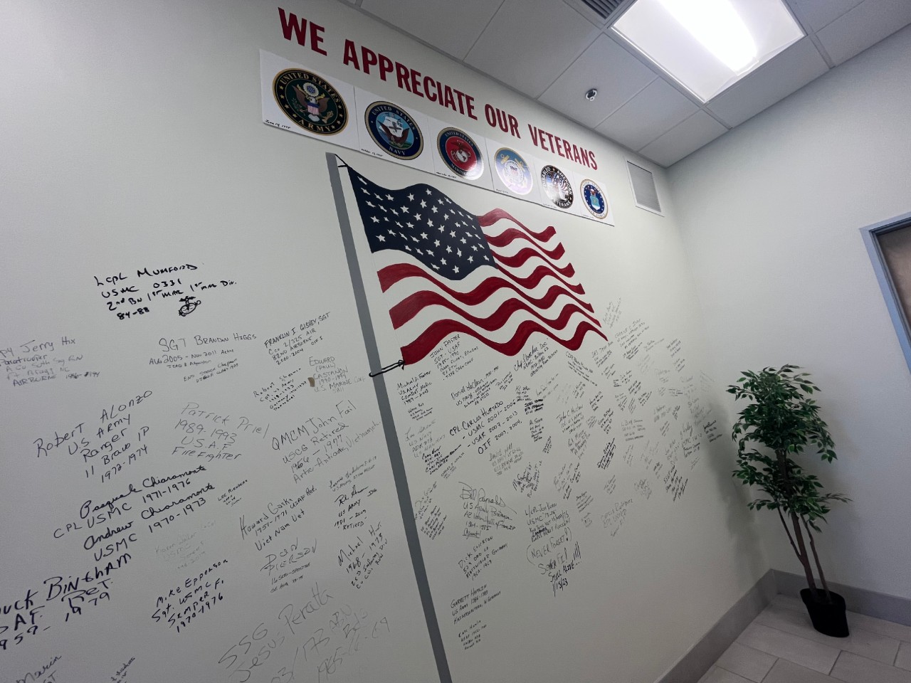 veteran wall with signatures and flag