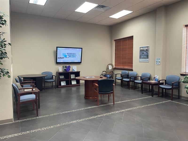 waiting area with couches and tv