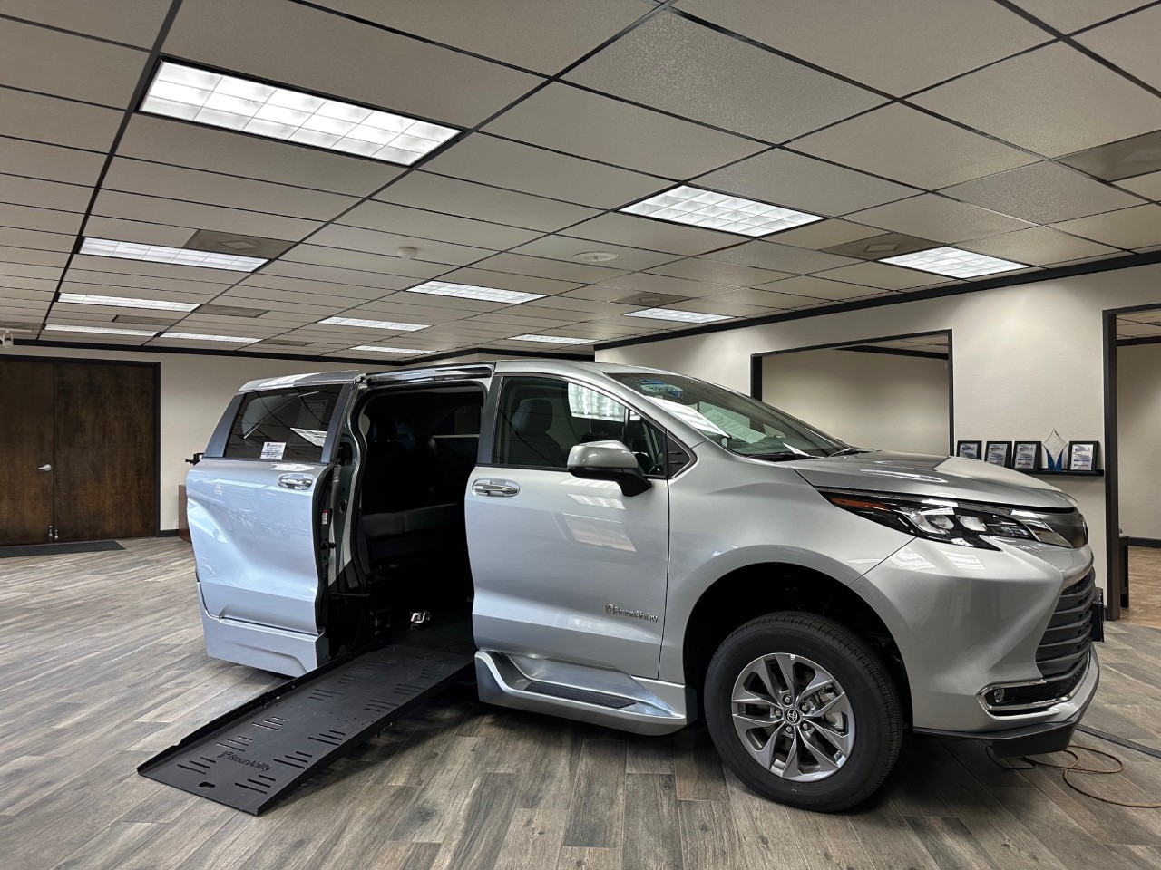 silver wheelchair accessible van with ramp deployed