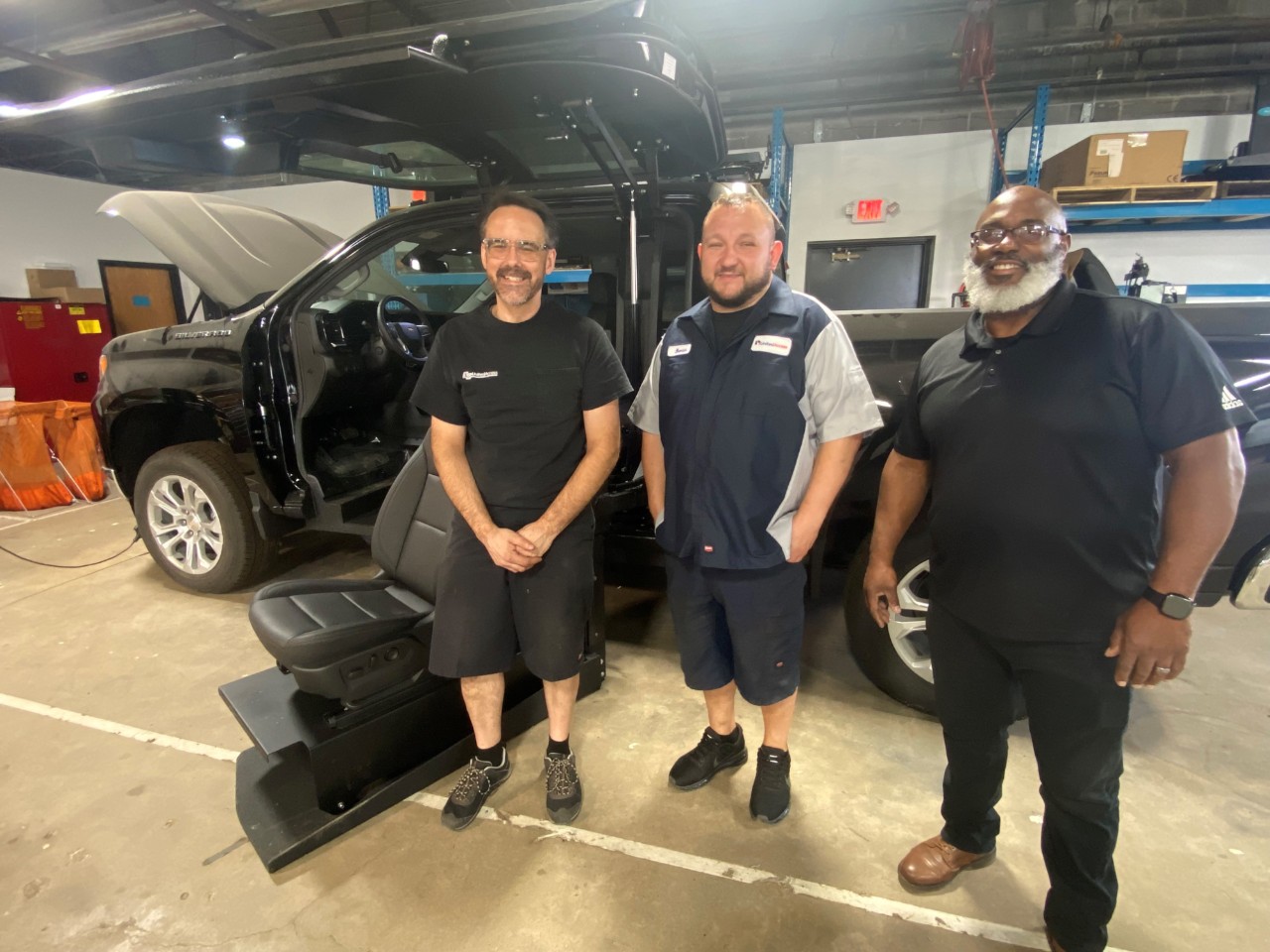 service team in front of a wheelchair accessible truck