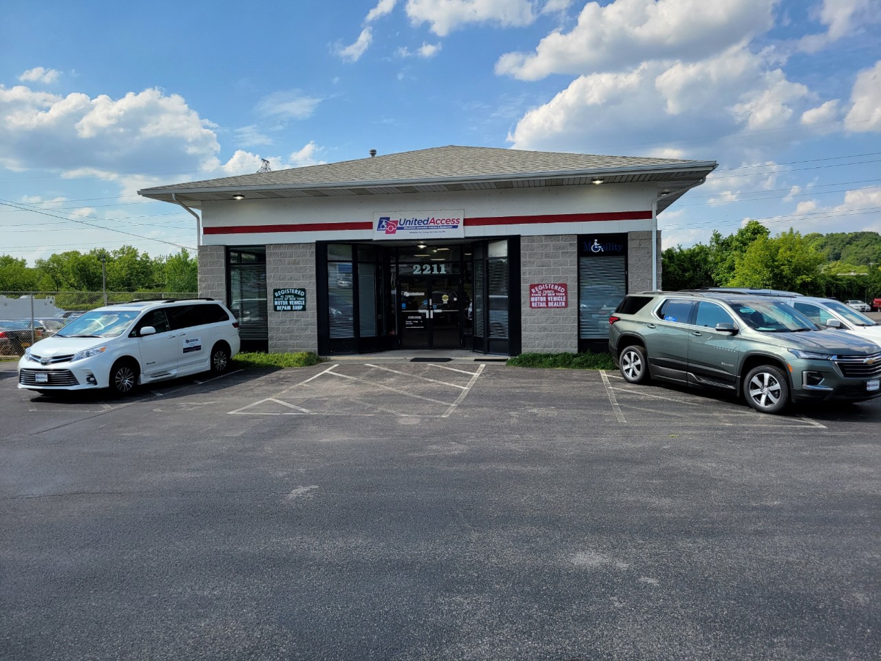 front of building with two accessible vans