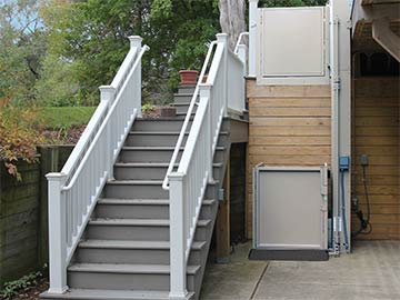 Bruno Residential Vertical Platform Lift installed on house by stairs