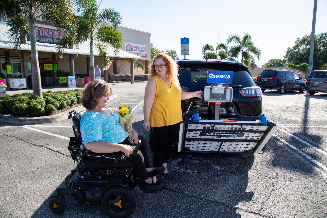 Harmar AL500 Scooter powerchair lift women with vehicle