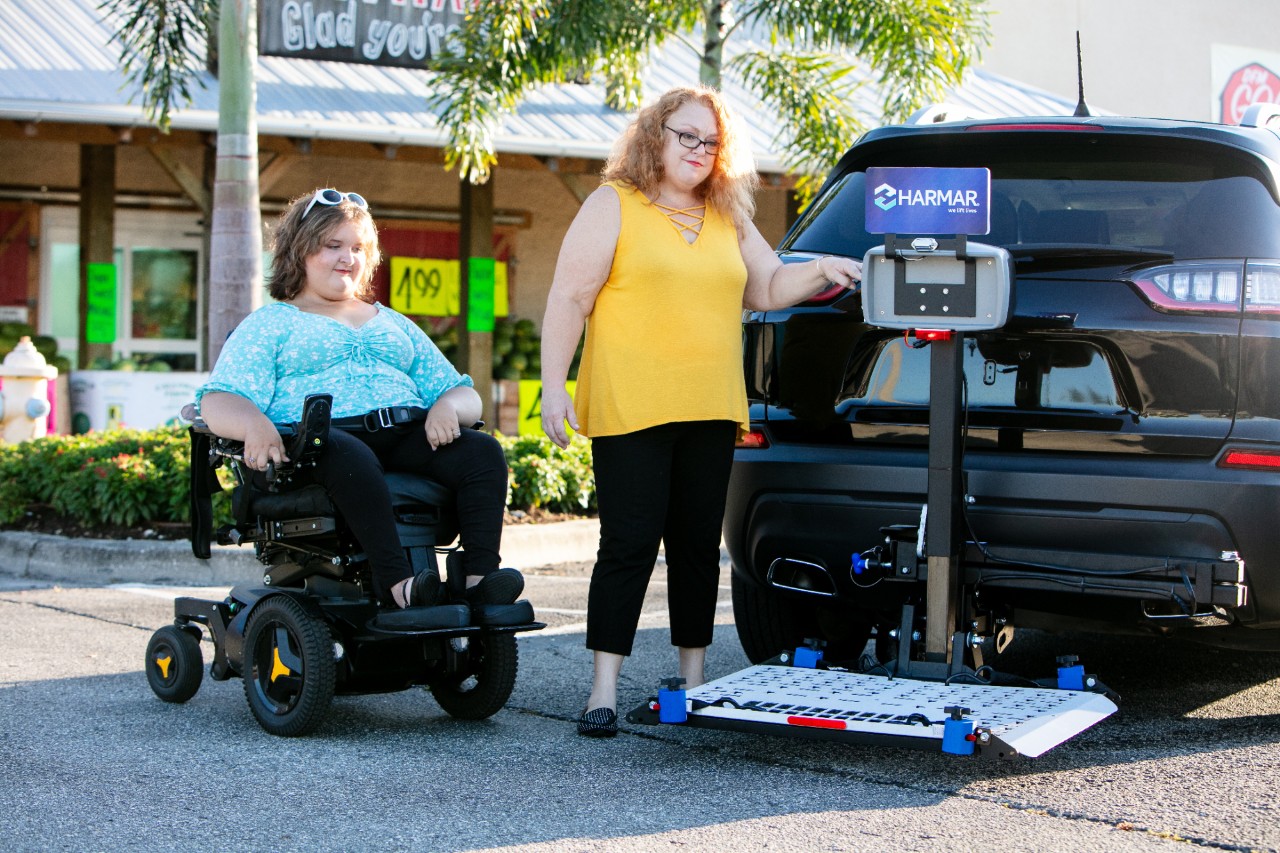 Harmar AL500 Scooter powerchair lift women with vehicle
