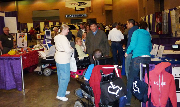 group viewing vendor booth at Abilities Expo