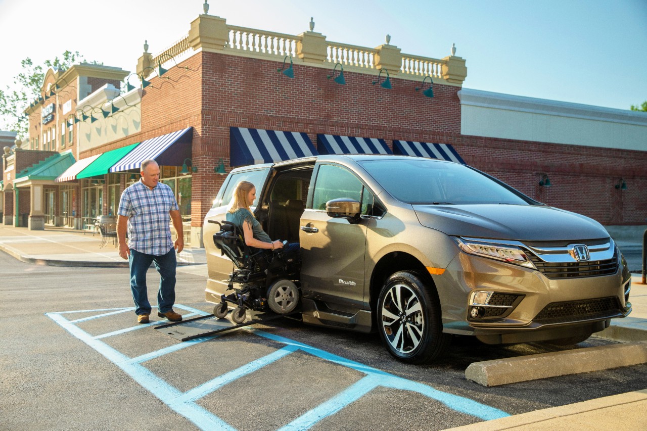 Caregiver and scooter user using Honda Odyssey with ramp